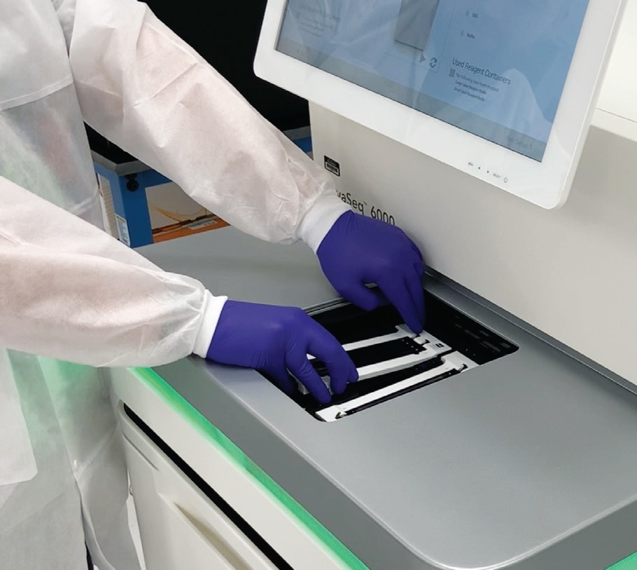A technician loading a DNA sequencer